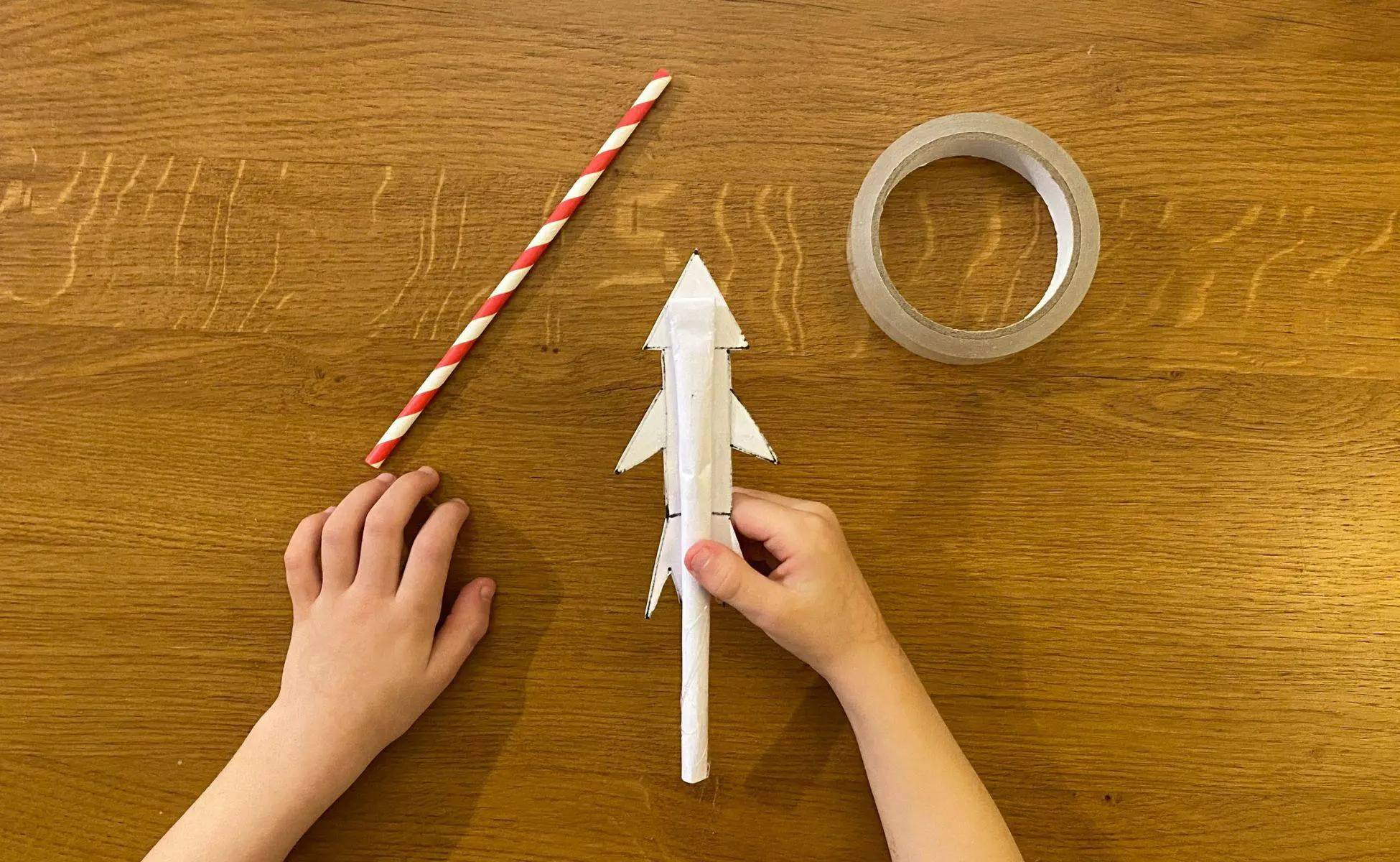 Straw Rocket activity - step 8 - Winston's Wish Step 8 With the open end to the bottom tape the tube to the back of the rocket then place your straw in the tube part of the rocket - straw rocket - Winston's Wish