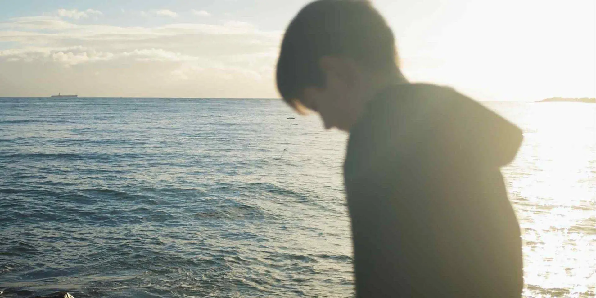 Young boy looking out to sea - helping a child talk about grief - Winston's Wish
