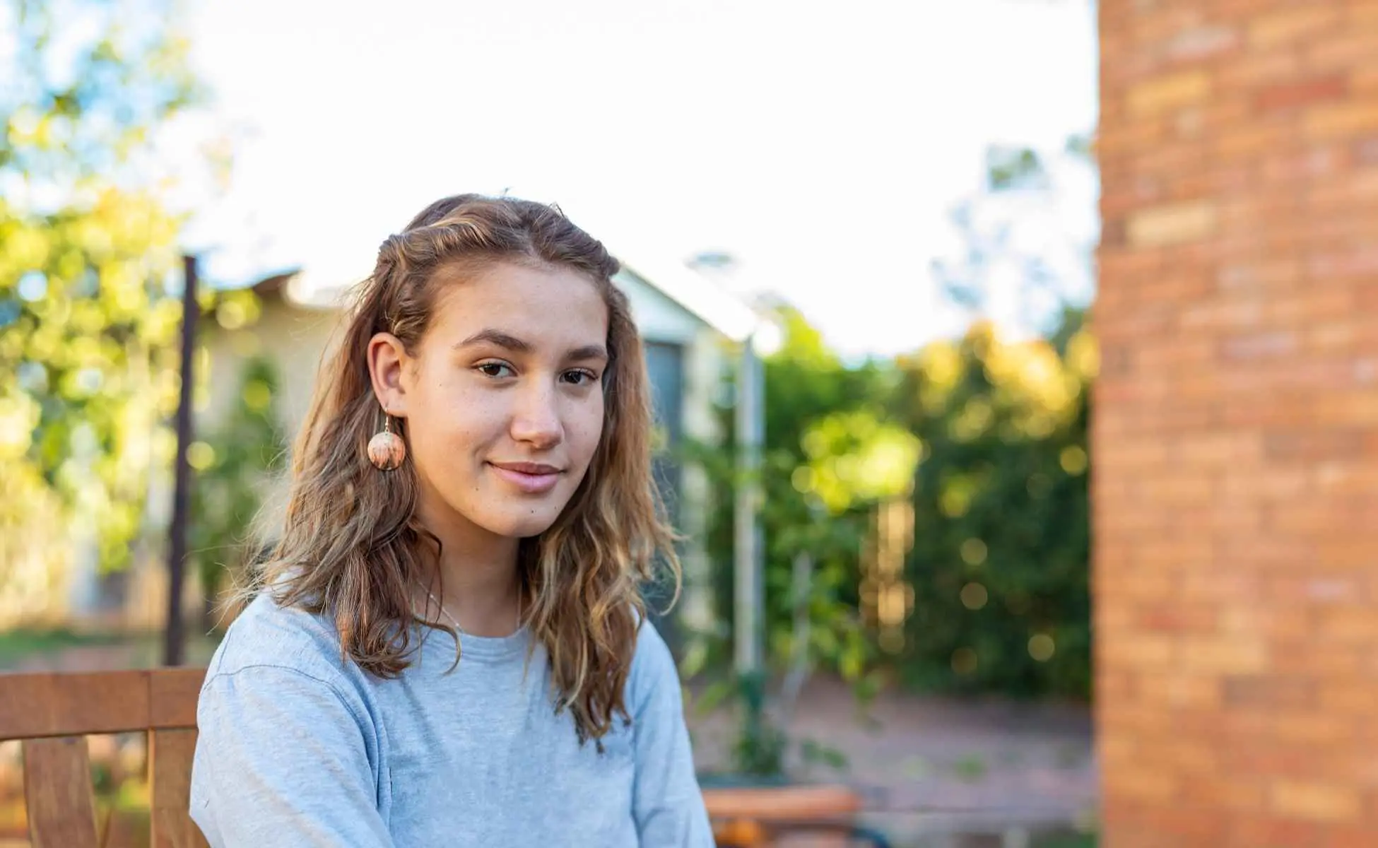 Teenage girl sitting on a bench