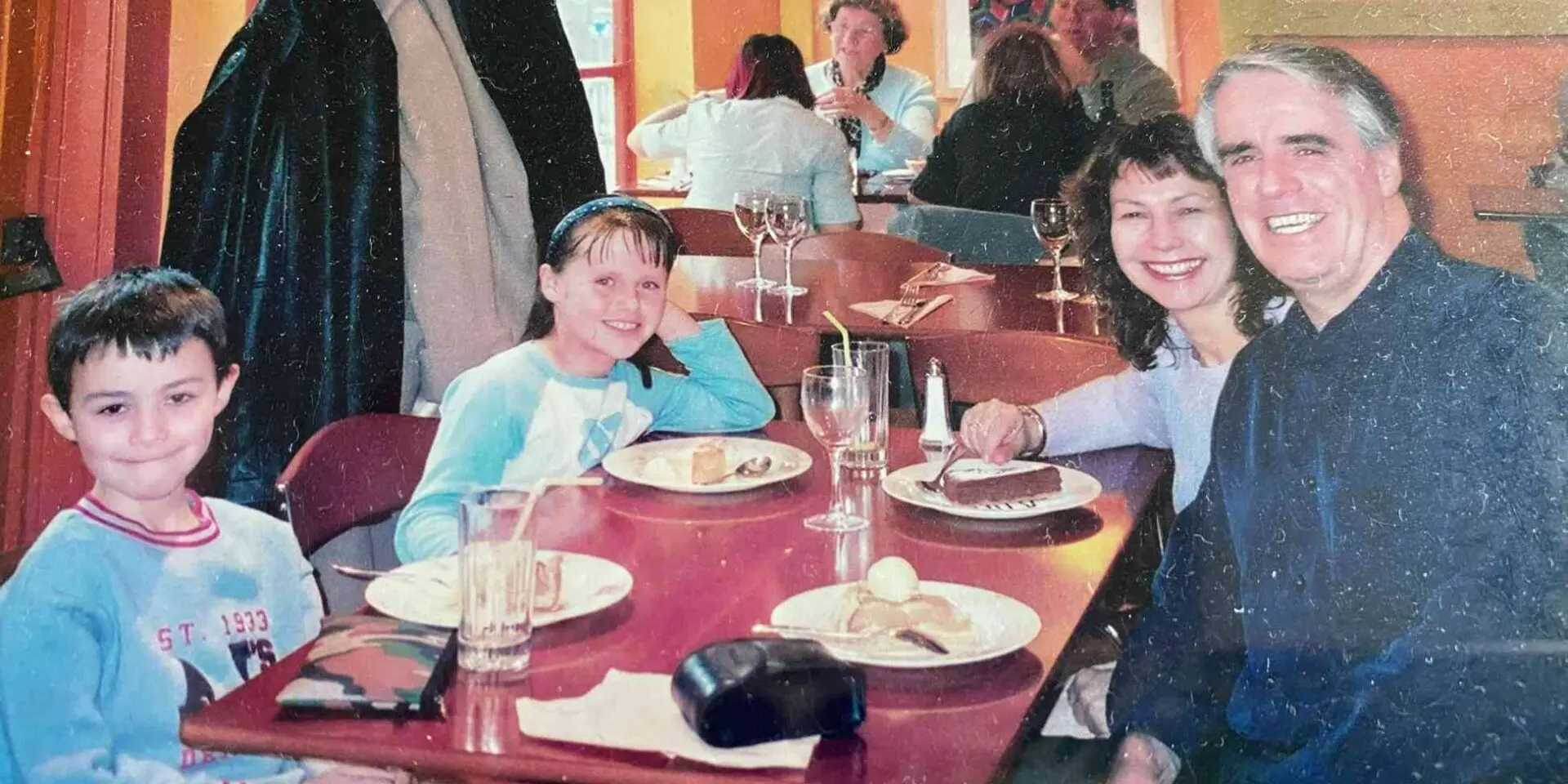 Family photo of Jane, Chris and their children at a dinner table