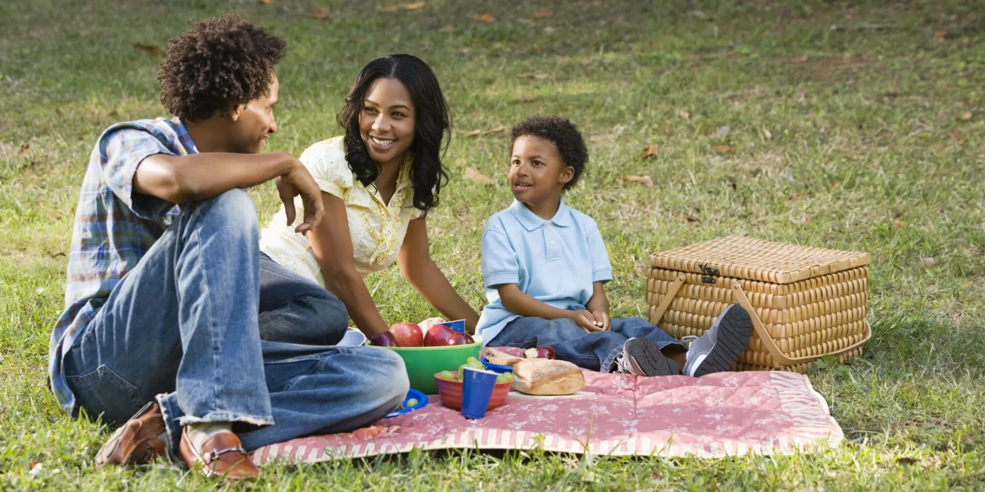 Young family enjoying a picnic in the park during the summer holidays