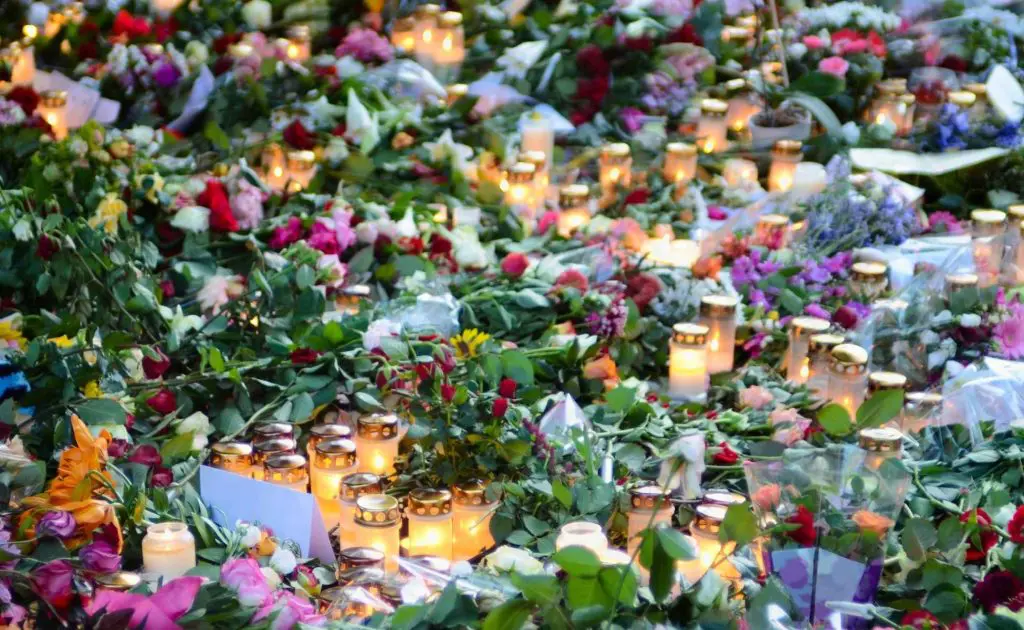 Flowers and candles laid as tribute to a celebrity