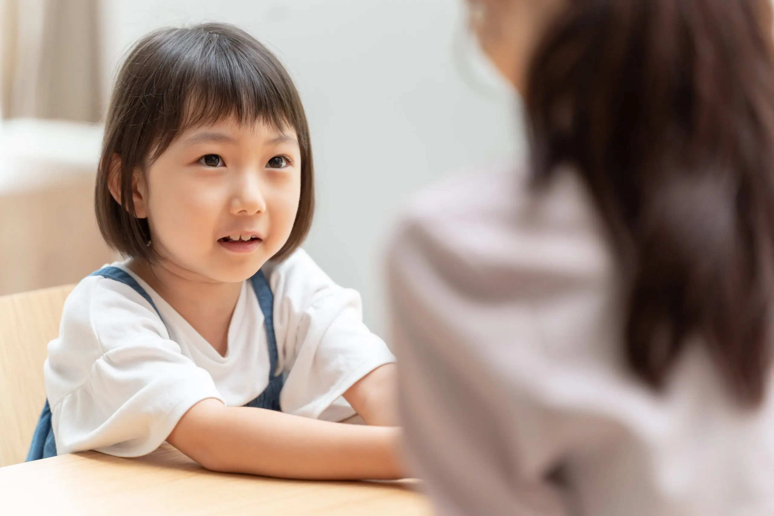 Young Asian child looking at parent.
