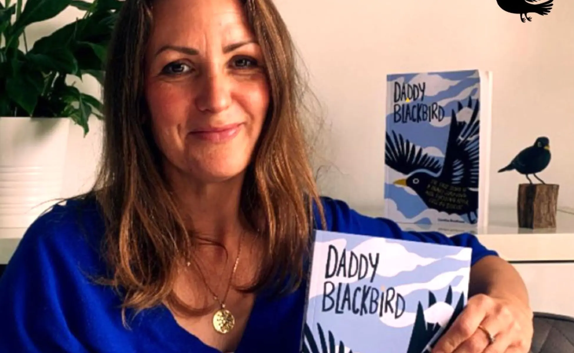 Caroline's Story Caroline holding her new book, Daddy Blackbird.