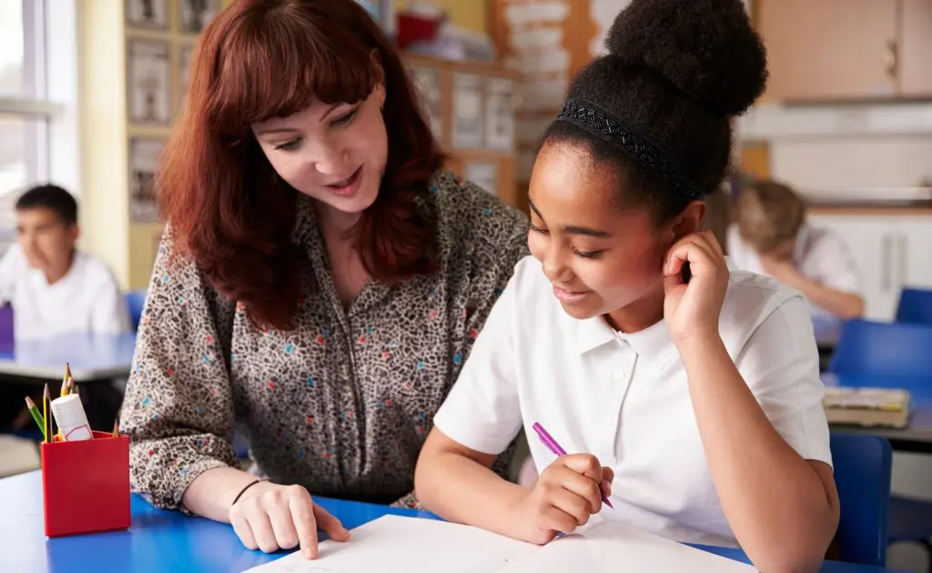 School girl with teacher in a classroom