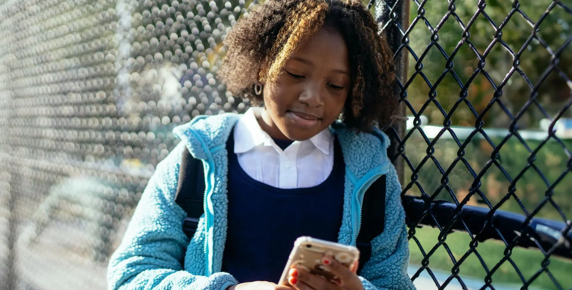 Young child on her phone - impact page