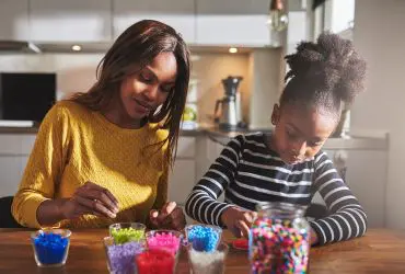 Anniversaries Woman with young child doing crafts together - navigating anniversaries, birthdays and special days