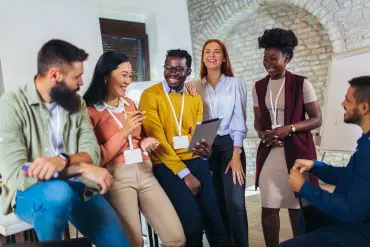 Corporate Page Corporate Spotlights A team of corporates sat around laughing and smiling