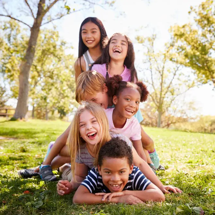 Turn Up the Dial: Group of children piled on top of one another to show inclusivity