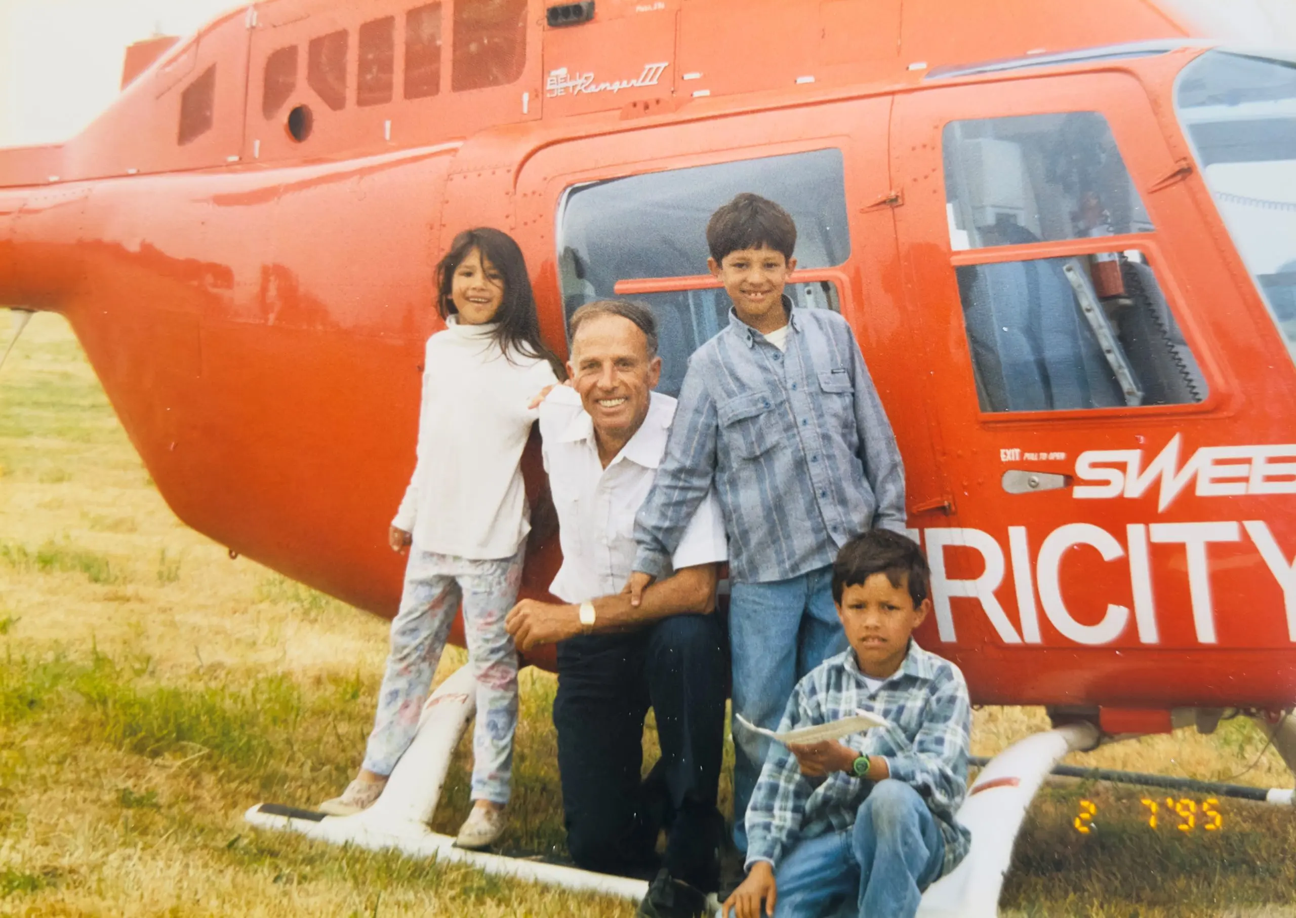 edd memory meadow A father and his three children posing in front of a helicopter.
