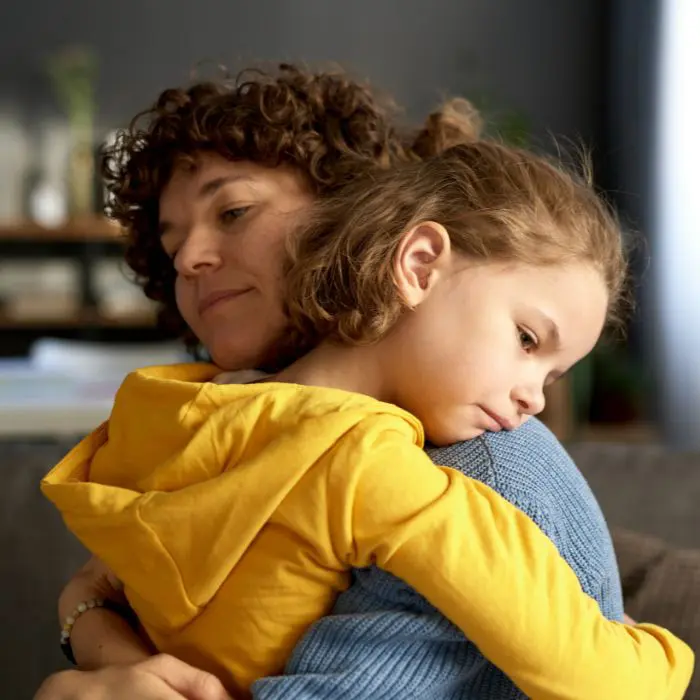 Attending a funeral Small child hugging her parent: Should children attend a funeral or cremation