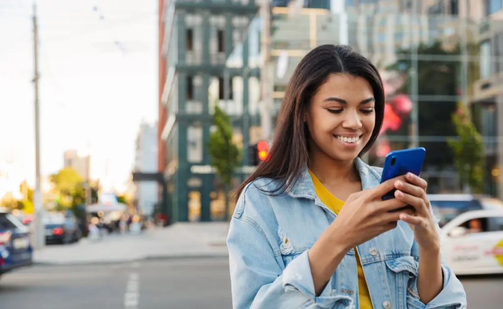 Winston's Wish is open over summer featuring a young girl on her phone, outside