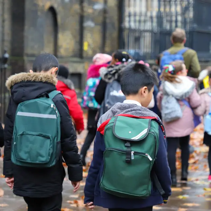 Supporting a child after a death in a school Supporting a child after the death of a friend in school. Image featuring school children walking towards the school gates