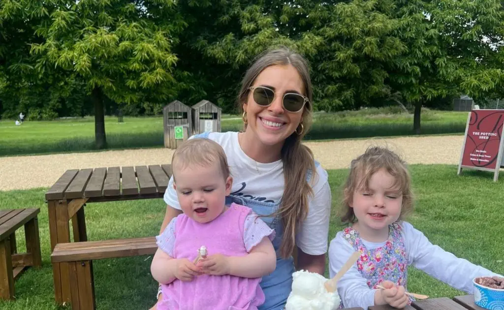Astrid and her two young girls sat on a picnic bench