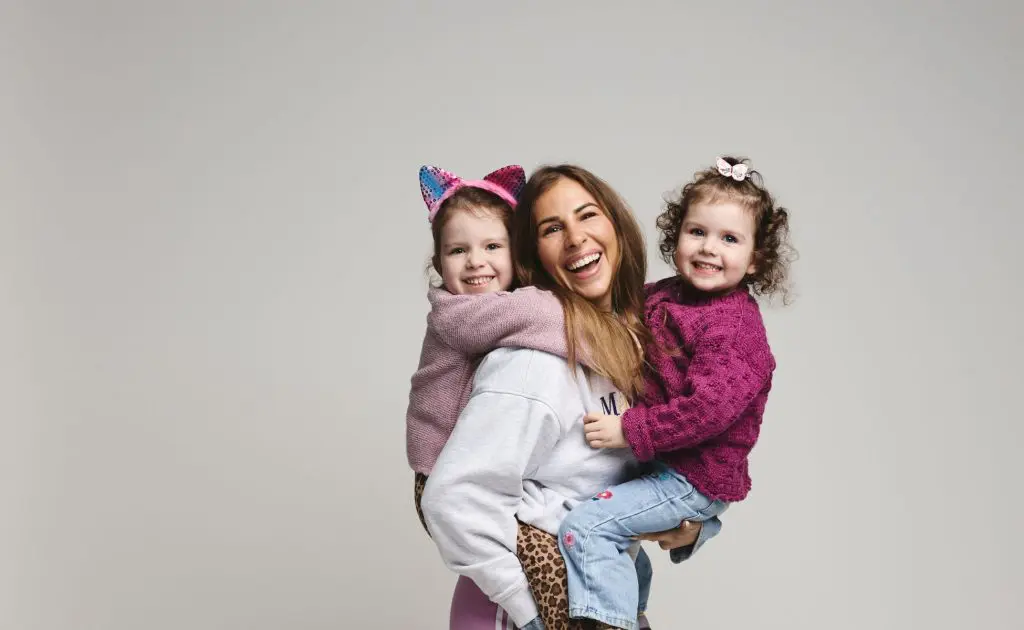 Astrid holding her two young girls
