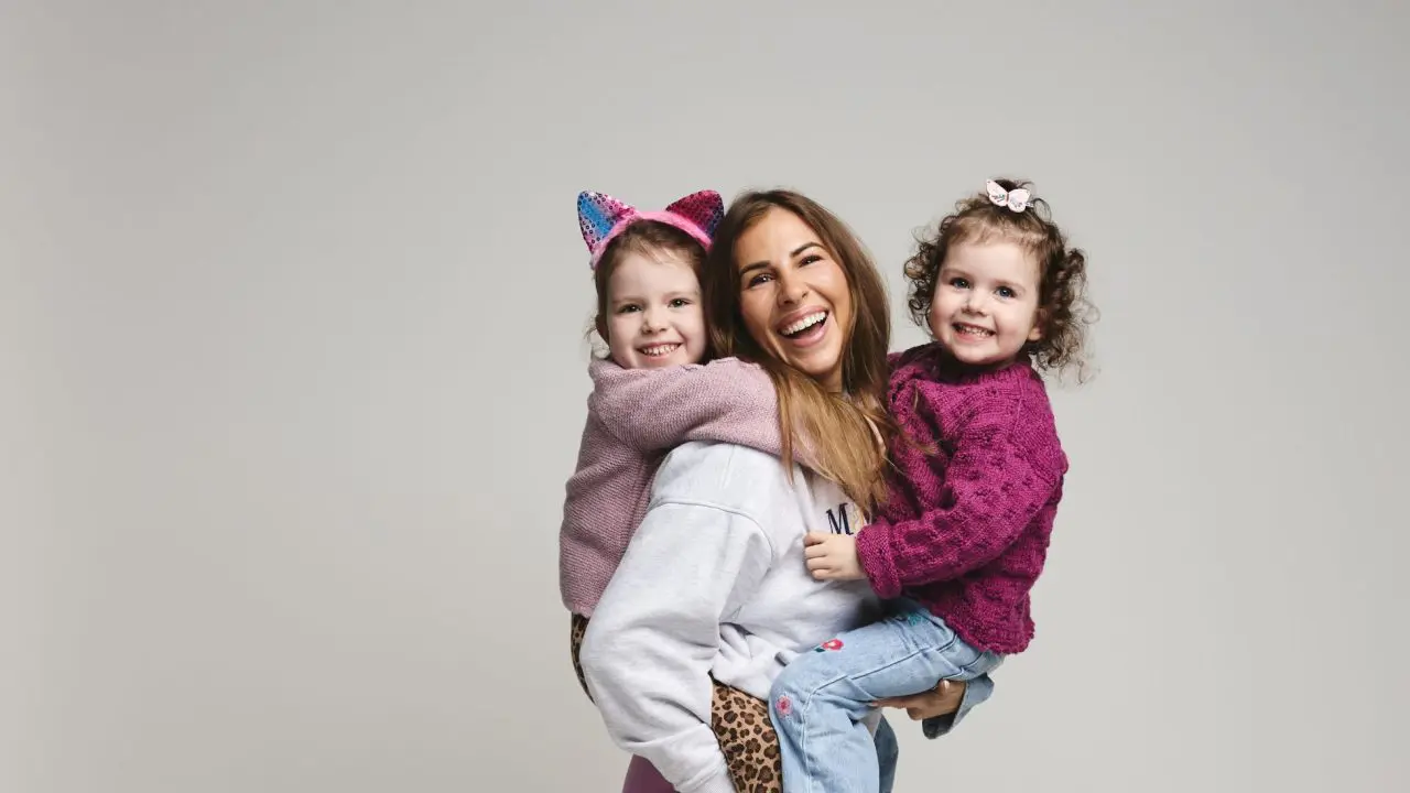 Astrid holding her two young girls