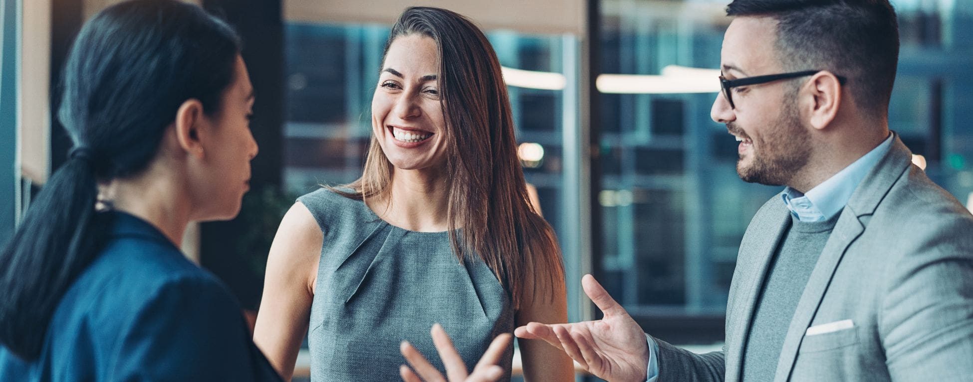 Business people talking and laughing to represent Payroll Giving