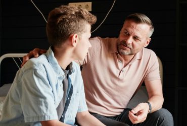 Parent sitting and talking to young teenage child