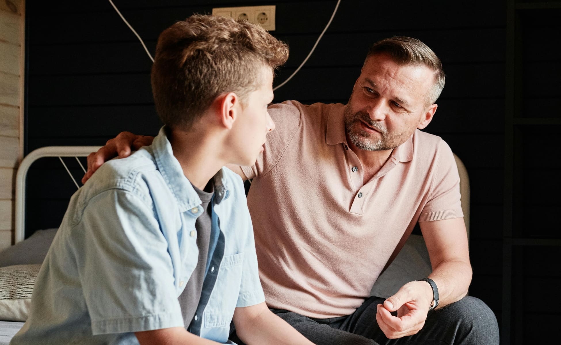 Parent sitting and talking to young teenage child