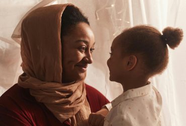 Bereavement support and advice header Bereavement support and advice header, featuring a Asian woman holding wearing a head scarf and holding her young child