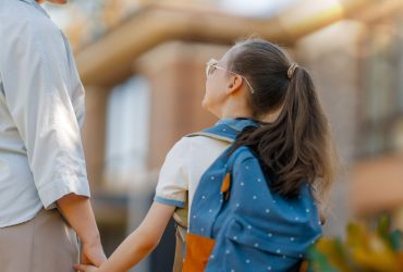 Back to school WAY School child with backpack holding mum's hand