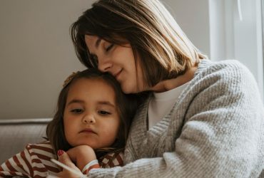 How can I support a child or young person when someone important to them has a serious illness Parent sitting next to young child reading